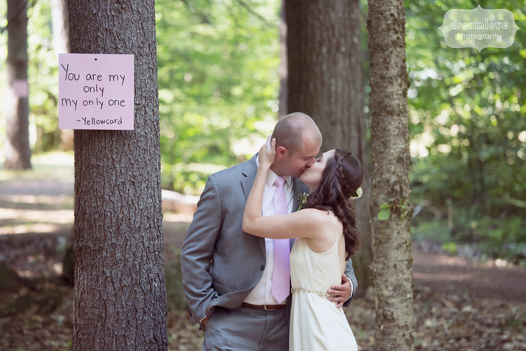 Great pose idea for the bride and groom kissing in the woods at the Woodbound Inn in NH.