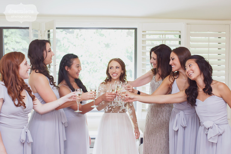 The bride is surrounded by her bridesmaids for a toast before the wedding at the Topnotch Resort in Stowe, VT.