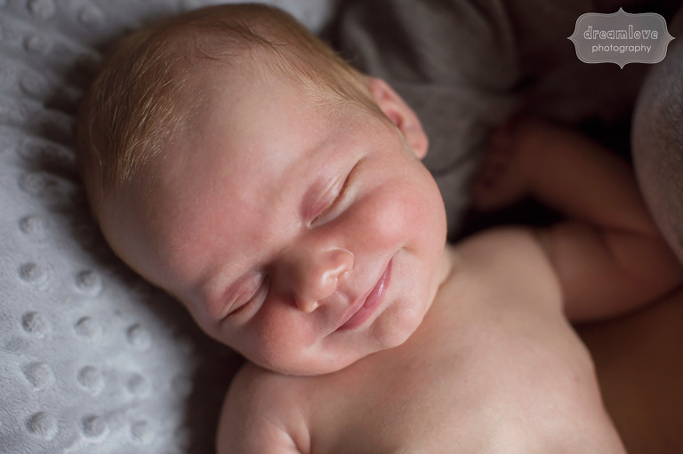 A newborn baby does a smile in his sleep during a newborn photo shoot in Venice.