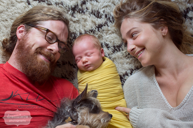 Natural and relaxed family photo of parents with newborn and dog in Venice, CA.