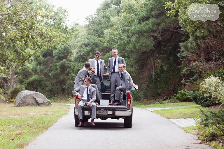 Funny photo of the groomsmen in the back of a pickup truck on Cape Cod.