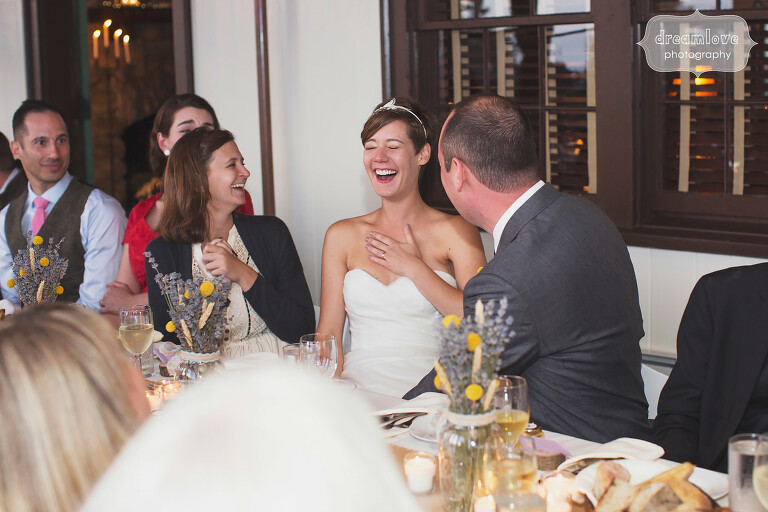 Bride laughing during speeches at this rustic Berkshires wedding venue in MA.