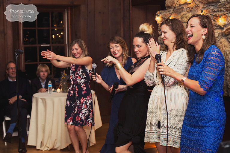 Funny girls doing karaoke at wedding reception in Western MA at Bascom Lodge.