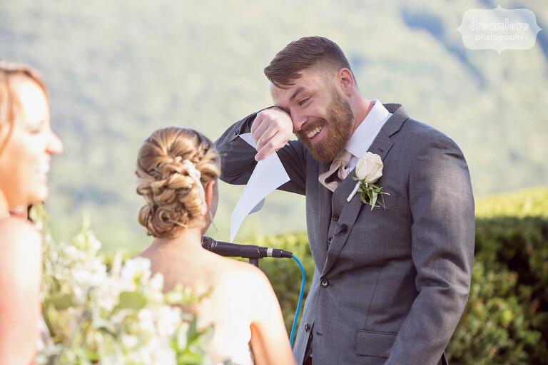 Emotional photo of the groom wiping away tears while crying during his vows at the Warfield House Inn.