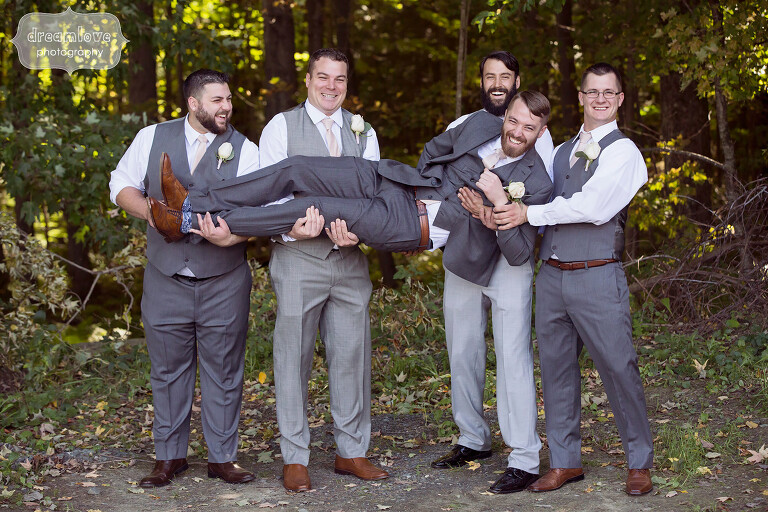 Funny photo of the groomsmen picking up the groom at this berkshires wedding.