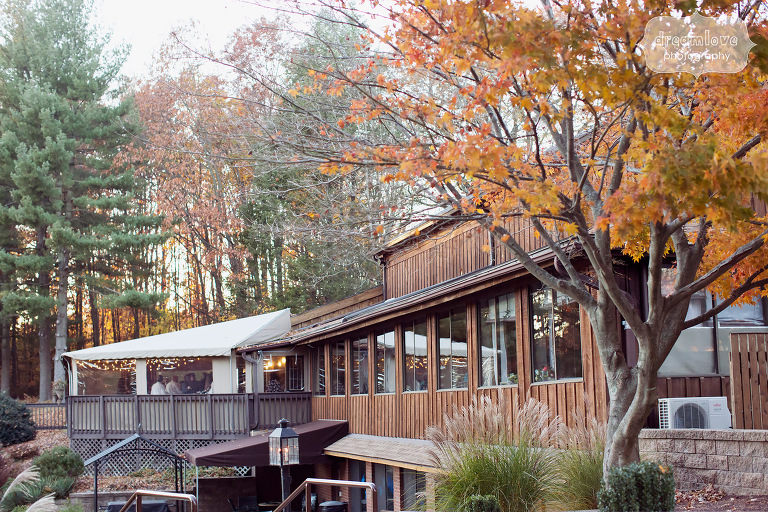 View of the rustic wedding venue, the Crystal Lake Pavilion in CT with scenic fall lake views.