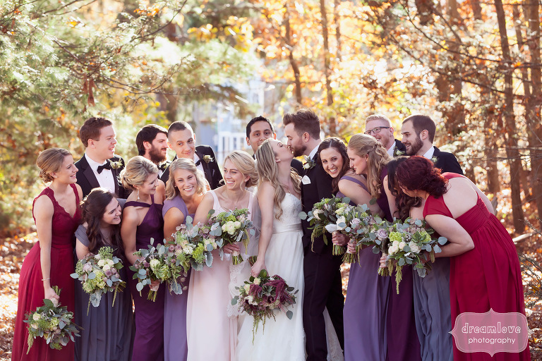 Cozy photo of a large wedding party in the woods at the Crystal Lake Pavilion in November.