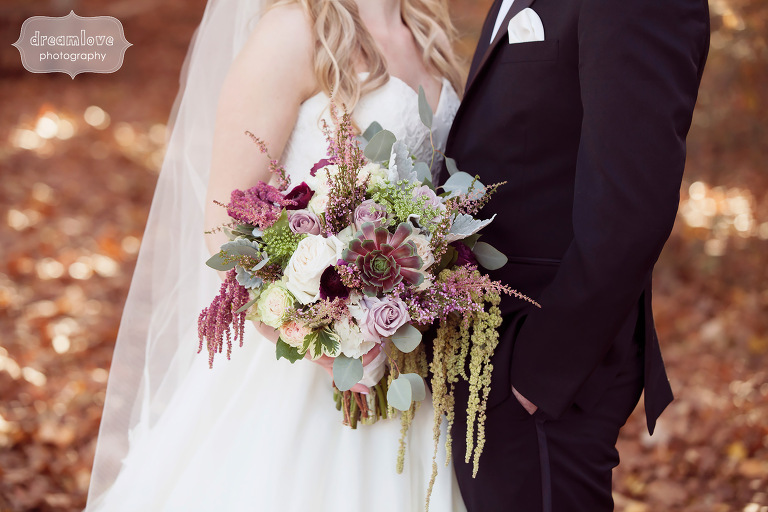 Bride carrying a succulent bouquet for a fall wedding by That's So Ranunculous floral shop in CT.