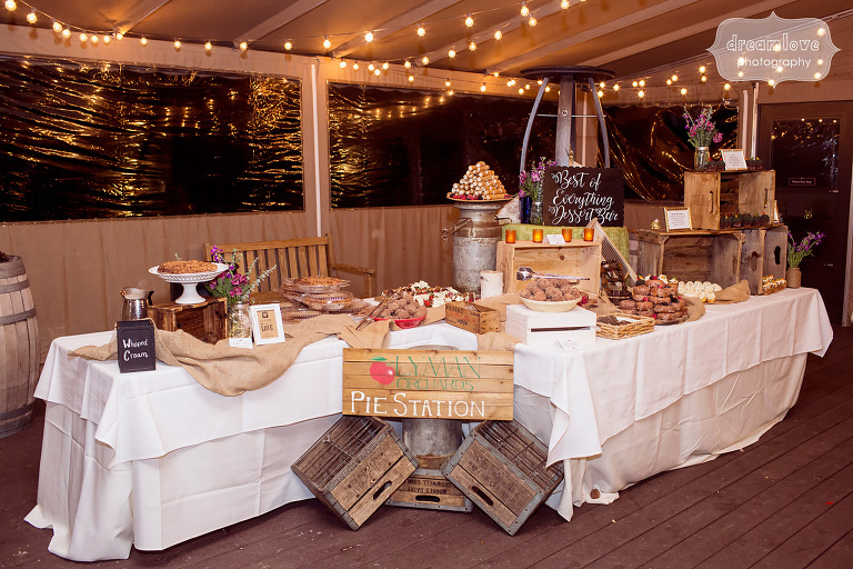 Rustic dessert table set up with wooden crates and a variety of local sweet treats for this CT wedding from Lyman Orchard.