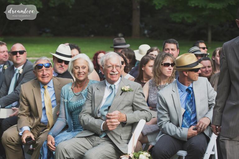 Candid wedding photo of the guests waiting for the outdoor ceremony to begin at the Lyman Estate historic greenhouse in MA.