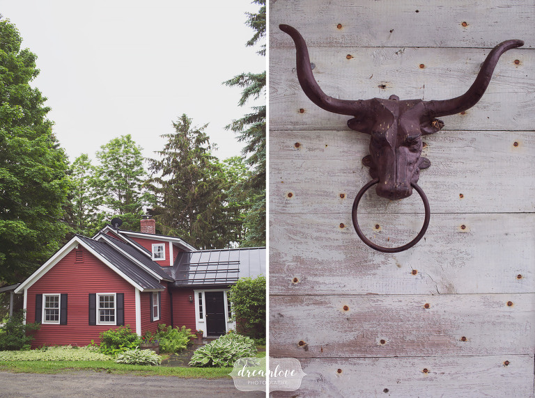 Red farmhouse on the property at the Stowe Comfort Farm barn, a rustic wedding venue.