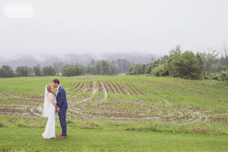 A natural wedding portrait of the bride and groom surrounded by rolling green hills along the Stowe Quiet Path.