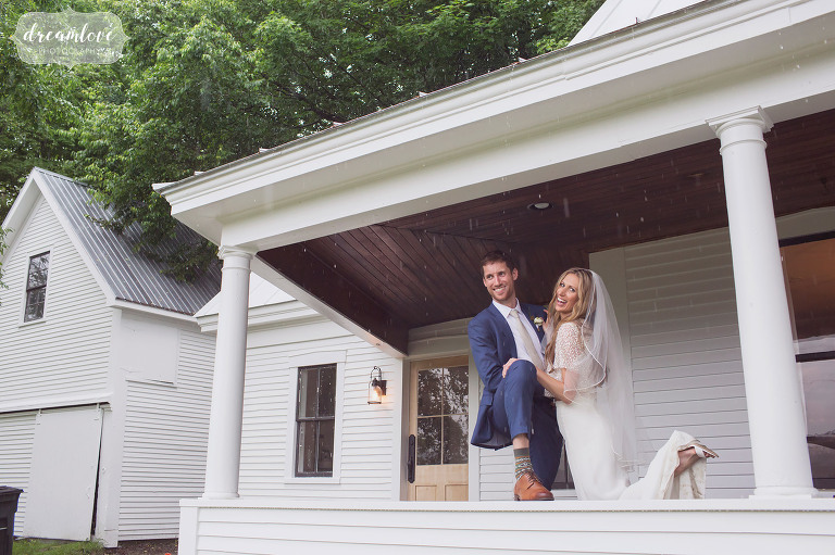 Fun wedding photos of the bride and groom on a covered porch in the rain in Stowe.
