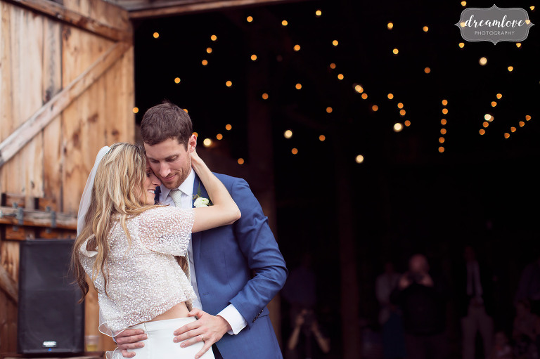 The bride and groom have a romantic first dance outside at their Stowe, VT barn wedding.