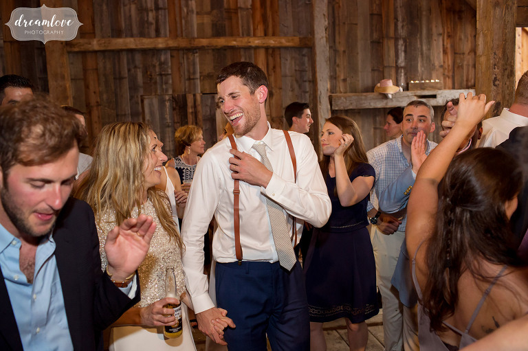 The bride and groom smiling with each other on the dance floor at their barn wedding in Stowe.