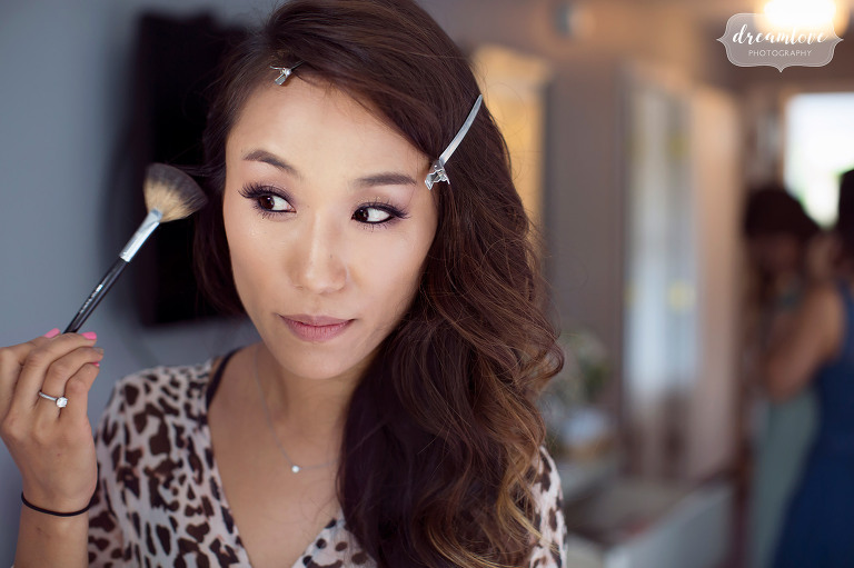A Korean bride puts makeup on at the Inn on Main before her outdoor wedding in Wolfeboro, NH in July.