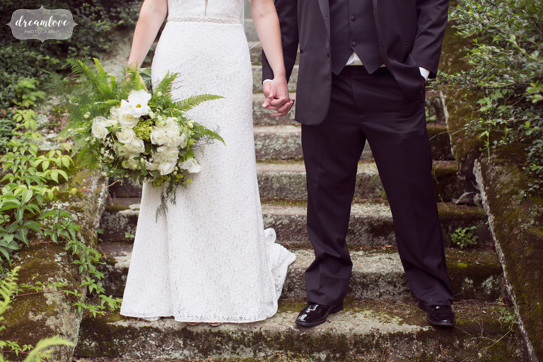 Natural wedding photography of the bride and groom holding hands on the garden stairs at Moraine Farm.