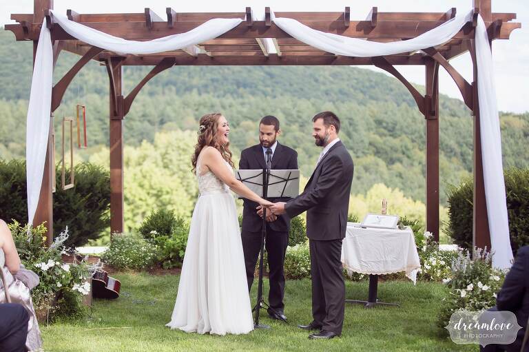 Happy pic of the bride and groom surrounded by mountains during their outdoor ceremony at Warfield House Inn.