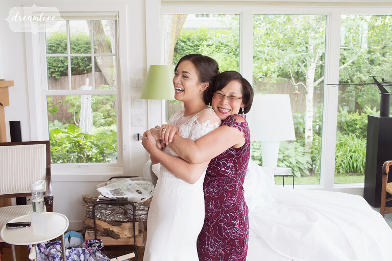 Great documentary photo of the mother of the bride hugs her daughter before her NY camp wedding.