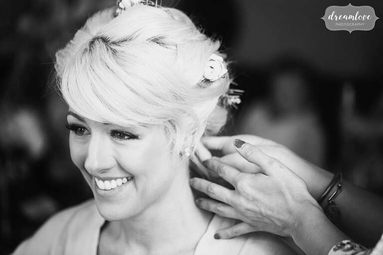Documentary wedding photography of the bride having hair done at Bishop Farm.