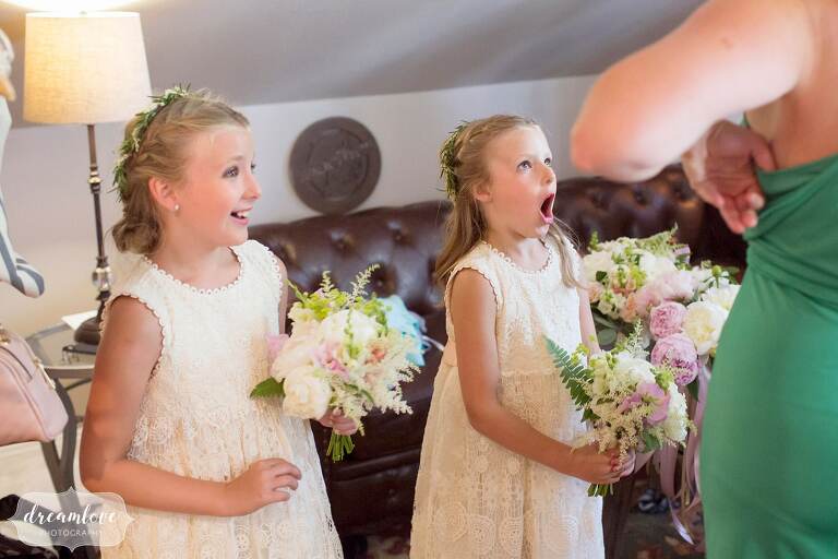 Documentary wedding photos of the flower girls seeing bride for first time.