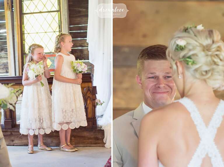 The flower girls cries during barn ceremony at Bishop Farm wedding.