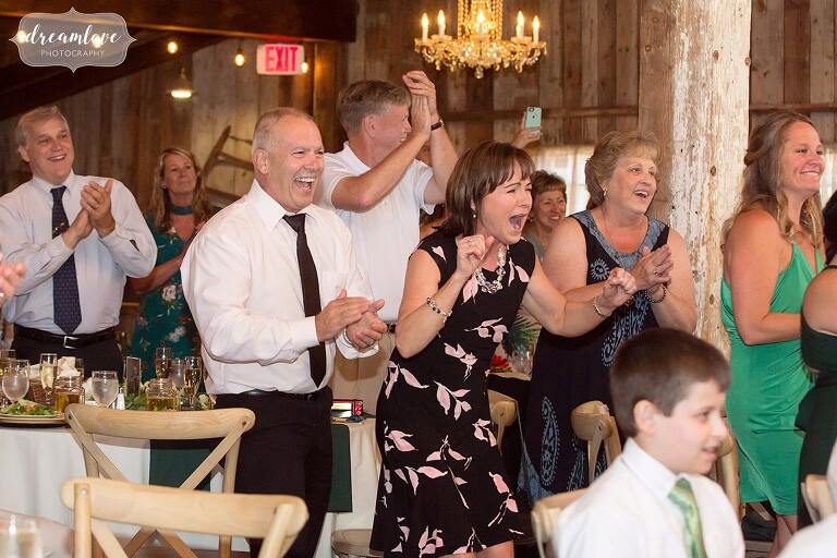 Guests react while kids perform a dance at Bishop Farm wedding.