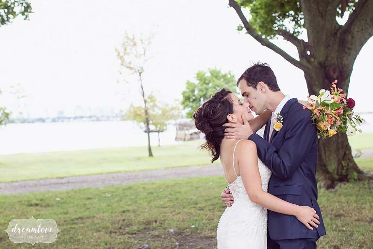 Bride and groom kiss at Boston Harbor wedding.