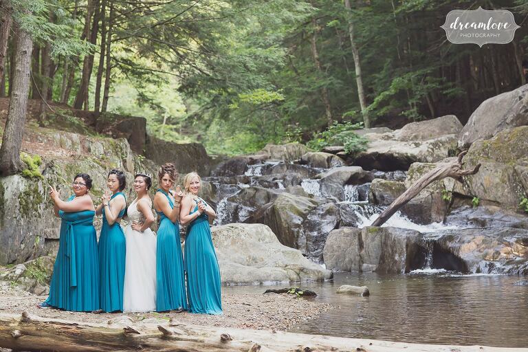 The bridesmaids do a Charlie's Angels pose by the creek in Hanover, NH.