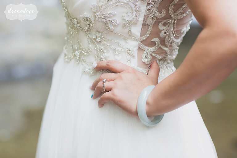 Fine art wedding photographer with bride in lace dress and teal bracelet.