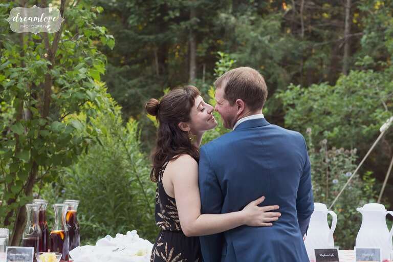 Candid photo of wedding guests kissing.