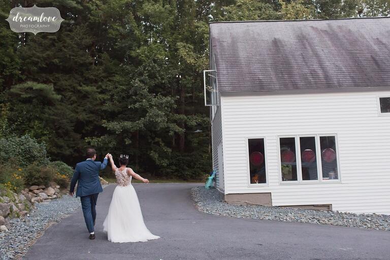 Silly bride and groom walk to dance floor in NH.