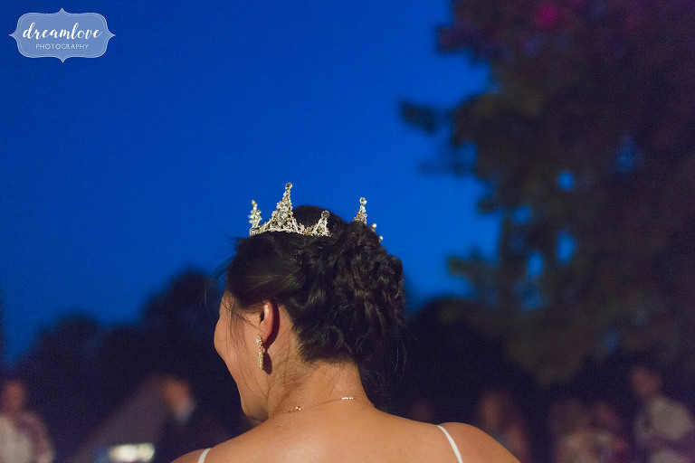 Bride wears sparkle crown with twilight during wedding reception.