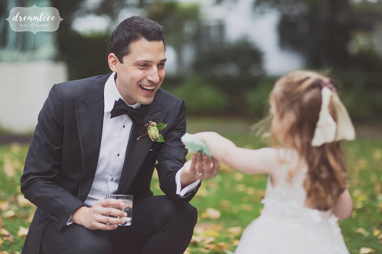 The groom talks with the flower girl at the Linden Place Mansion.