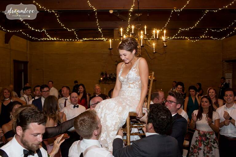 The bride is lifted up on a chair during the Hora at the Linden Place.