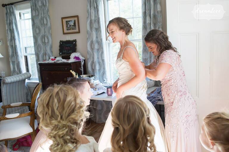 The bride puts her Kleinfeld dress on at the Windsor Mansion venue in VT.