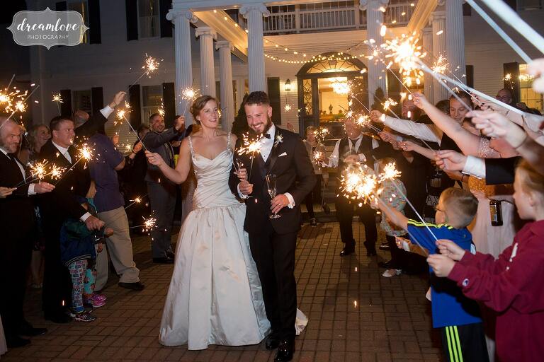 Bride and groom exit through sparklers at Windsor Mansion.