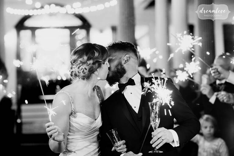 Classic photo of bride and groom with sparklers at Windsor Mansion venue.