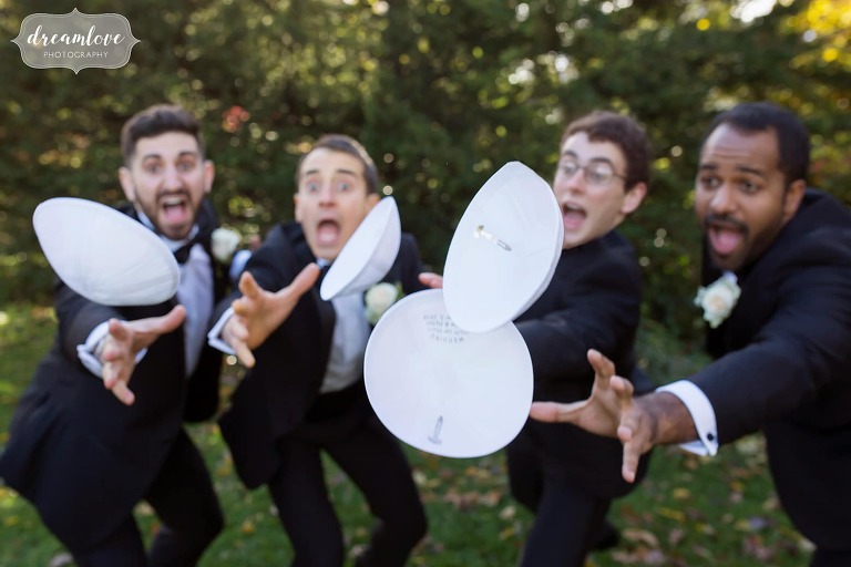 Funny photo of groomsmen with yamakas flying in the wind.
