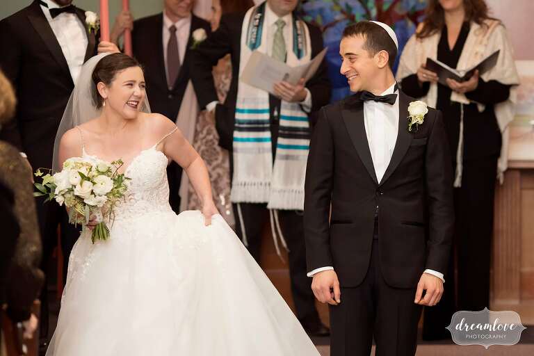 Bride and groom look at each other during Boston jewish wedding at Temple.