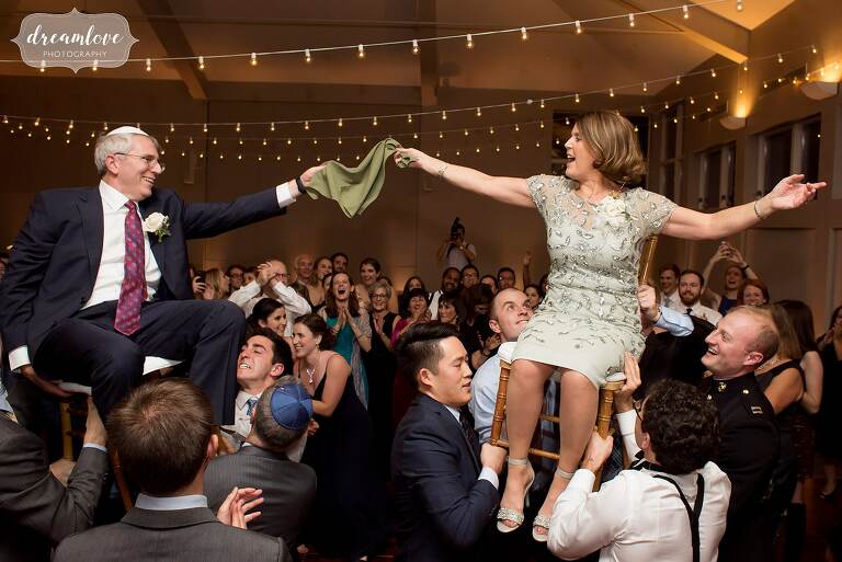Parents are hoisted on chairs for this traditional Jewish wedding dance.