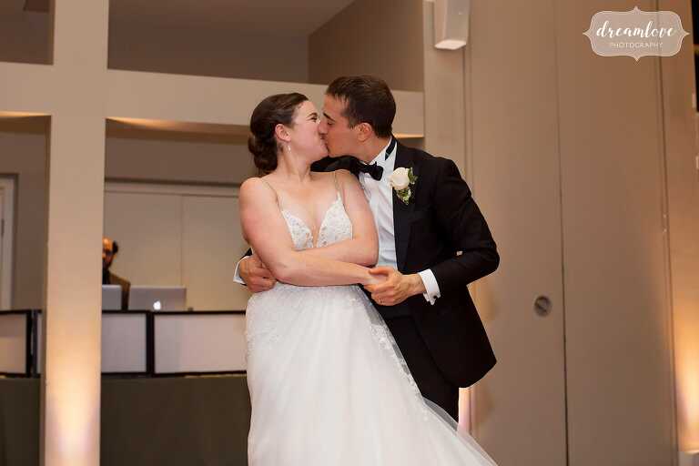 Bride and groom kiss at the end of their Temple Shir Tikva Jewish wedding reception in Boston.