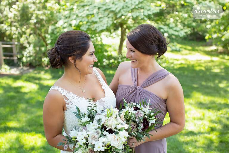 Bride poses with her bridesmaid in lilac at Bradley Estate.