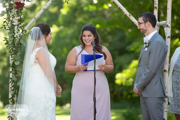 Bridesmaid reads during ceremony at Bradley.
