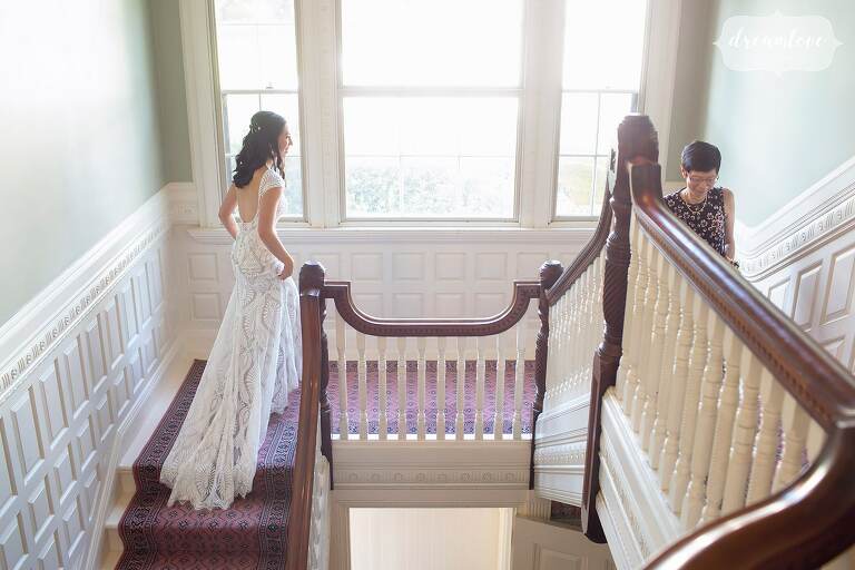 Bride walking up staircase with modern pattern wedding dress at Lyman Estate.