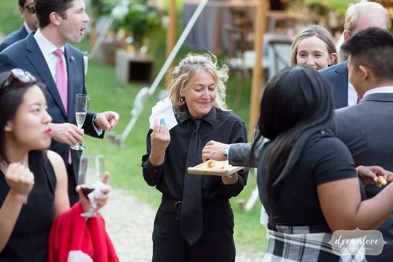 Capers Catering staff hands out mini lobster rolls at Lyman Estate.