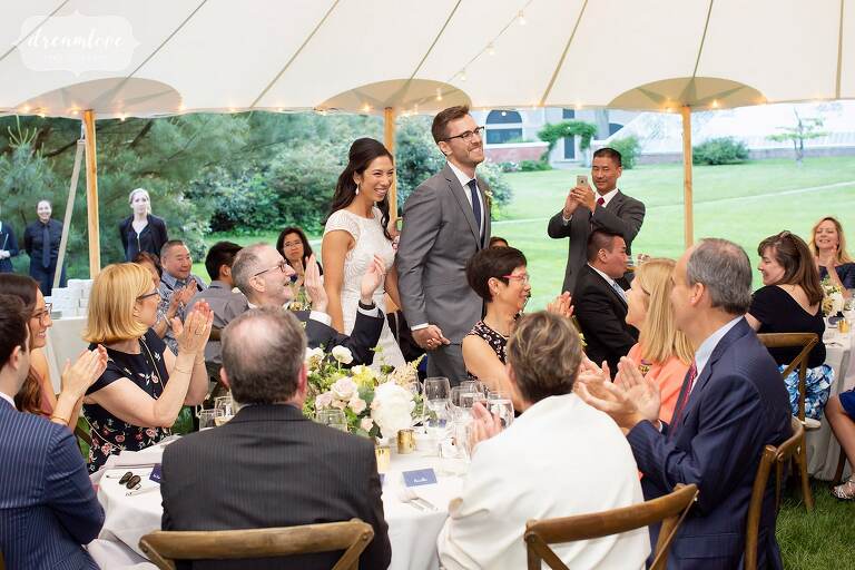 Bride and groom enter the reception tent at Lyman Estate.