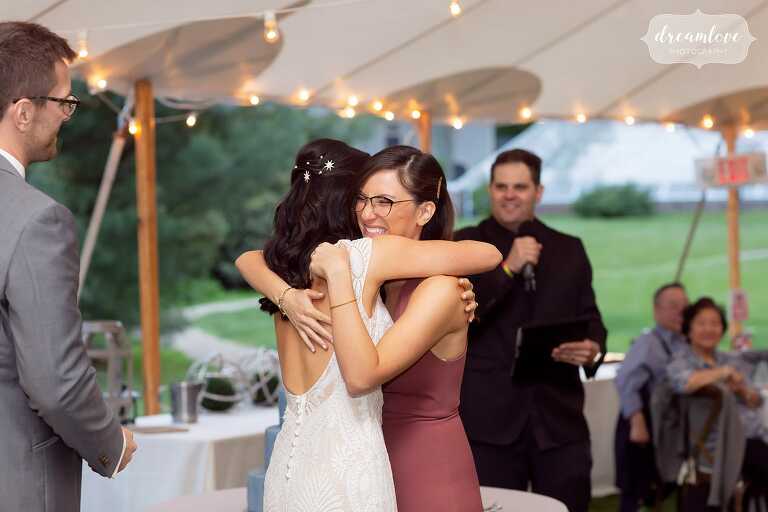 Bride and her sister hug after toast at Lyman Estate.