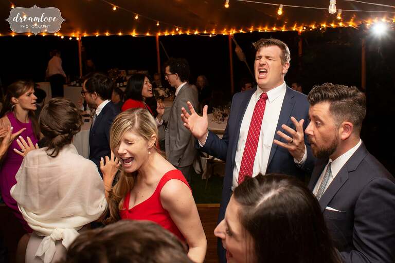 Hilarious guests sing along to wedding songs at Boston wedding.