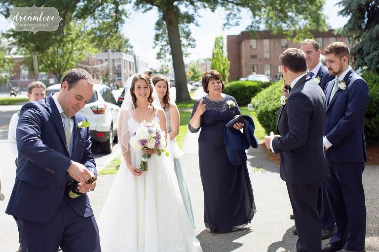 Wedding popping champagne outside of St. Mary's Church in Danvers, MA.